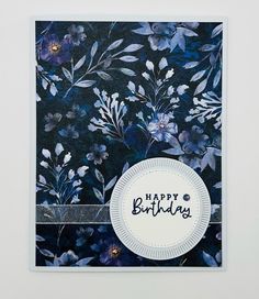 a card with blue flowers and the words happy birthday written in white lettering on it