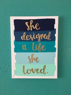 a sign that says she designed a life she loved on the side of a wall