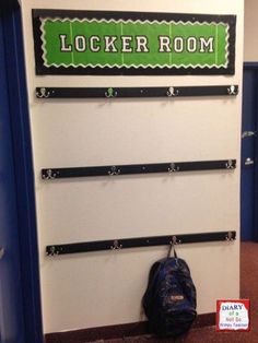 the locker room is decorated with black and green letters, along with a blue backpack