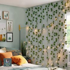 a bedroom decorated with plants and string lights