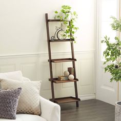 a living room filled with furniture and a tall wooden shelf