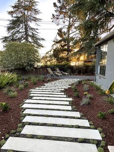 a stone path in the middle of a garden