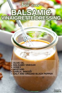 the ingredients for balsamic dressing in a glass jar with a spoon on top