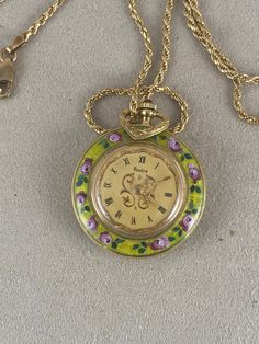 Vintage ladies 18 Karat Solid Gold Rondine Swiss 17 jewel open face pocket or pendant watch Fancy Hands Roman Numerals, with green Floral enameled case and Italian Gold Vermeil 2MM 24 inch Rope Necklace Chain hand-painted guilloche enamel with pink roses.on front bezel and a Floral Boutique on the reverse Inside Case is Marked 750 18K Watch diameter is approx. 1 3/16 inch in diameter. 22.5 Grams  Condition Enamel is free of chips along the edge of the back of the case. Watch is currently running Yellow Gold Chronometer Jewelry Gift, Yellow Gold Chronometer Jewelry For Gift, Yellow Gold Jewelry Chronometer For Gift, Yellow Gold Jewelry With Chronometer As A Gift, Green Medallion Necklace For Formal Occasions, Floral Boutique, Fancy Hands, Pendant Watch, Guilloche Enamel