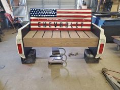 a truck bed with an american flag painted on it's back and the words chevy