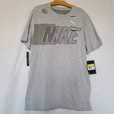 Nike Graphic Logo Gray T-Shirt 58% Cotton And 42% Polyester Nike Vest, Check Shirt Man, Shirts Nike, Nike Long Sleeve, Nike Shirt, Mens Graphic T, Dri Fit Shirt, Tiger T Shirt, Graphic Logo