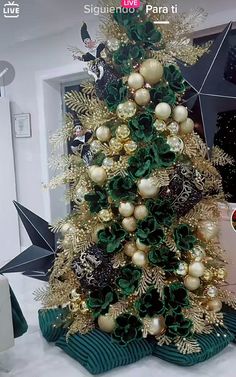 the christmas tree is decorated with gold and green ornaments