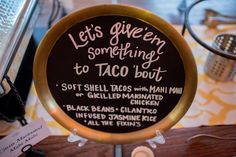 there is a sign that says let's given something to taco bout