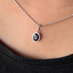 "Dark Royal Blue Sapphire is surrounded by tiny diamonds in a scattered halo. This pendant is a perfect gift idea. * Main Gemstone : Natural Untreated Blue Sapphire * Halo : Natural White Diamonds * Blue Sapphire : 6 x 8 mm ; 1.50 cts (Approx) * Diamond Weight : 0.20 cts * Color - Clarity Grade : H-I, Vs-Si (Halo) * Gold Weight Pendant - 1.2 gms. 14k Solid White Gold (Approx) Your purchase will arrive inside a lovely gift box. If you like this pendant, please press \"Pin it\" button on the right Oval Sapphire Necklace With Halo Setting, Sapphire Necklace With Oval Halo Setting, Oval Pendant Necklaces With Halo Design As Gift, Oval Halo Design Necklace, Gift Necklaces With Oval Pendant And Halo Design, Oval Pendant Necklace With Halo Setting, Oval Pendant Necklace With Halo Setting As Gift, Halo Oval Pendant Jewelry As Gift, Oval Pendant Halo Jewelry For Gift