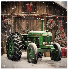 an old green tractor parked in front of a barn with christmas decorations and wreaths