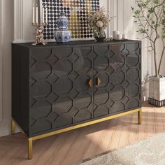 a black and gold sideboard with an abstract design on it's front door