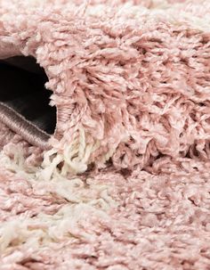 a close up view of a pink and white rug with fringes on the edges