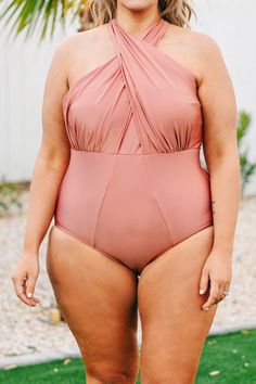 This swimsuit is perfect for your next beach trip! This swimsuit has a shimmery pink color that's perfect for the season! It has a classic one-piece fit, features a tied crisis cross halter neckline bust! Wear this swimsuit to every pool party on your calendar this Summer! 82% Polyamide, 18% Elastane Summer Halter Neck Swimwear With Crisscross Straps, Party Swimwear With Halter Neck And Cross-tied Details, Crisscross Strap Halter Top For Beach Season Pool, Crisscross Straps Halter Top For Beach Season, Halter Top With Crisscross Straps For Beach Season, Party Halter Neck Cross-tied Swimwear, Cross-tied Halter Neck Swimwear For Beach Season, Cross-tied Halter Neck Top For Poolside, Summer Swimming Halter Top With Crisscross Straps