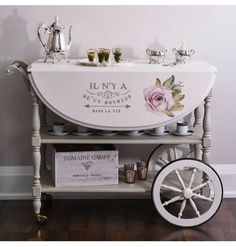 an old fashioned bar cart with flowers painted on it