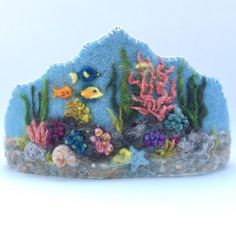 an ocean scene made out of felt with fish and corals