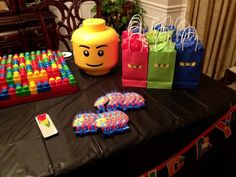 the table is set up with legos and bags for each individual to use as gifts