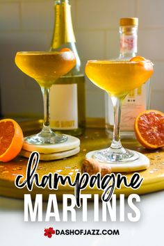 champagne martinis on a tray with orange slices