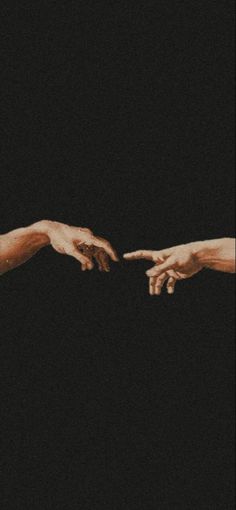 two hands reaching out towards each other in the middle of an image with black background