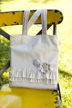 a white bag sitting on top of a yellow chair