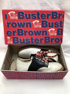 a pair of white and black shoes in a box with the words buster brn brown bush erbrown bro