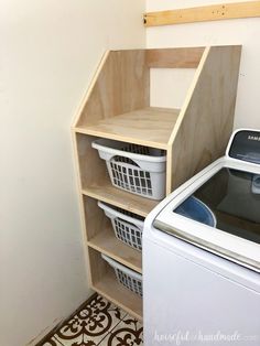 a washer and dryer sitting next to each other in a room with tile flooring