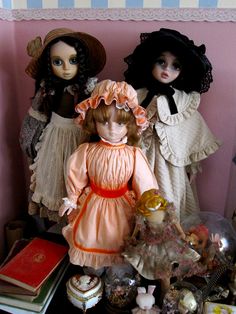 three dolls are standing next to each other