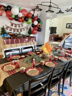 a dining room table set up for a holiday party with red, white and green decorations