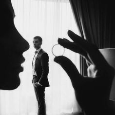 a man standing in front of a window next to a woman