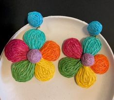 With a distinct 60's flower child vibe, these fun and brightly hued earrings are raffia over brass and sway nicely when you move your head.  Mint, hot pink, neon orange, bright yellow, sage and turquoise colors.  Lightweight, post back.  A 2 ¾" dangle length. 28-116 Handmade Multicolor Flower Earrings For Spring, Flower-shaped Earrings For Spring Vacation, Flower-shaped Earrings For Vacation In Spring, Flower Shaped Earrings For Spring Vacation, Handmade Vibrant Spring Earrings, Playful Multicolor Handmade Flower Earrings, Playful Handmade Multicolor Flower Earrings, Summer Multicolor Handmade Flower Earrings, Spring Vacation Flower Earrings