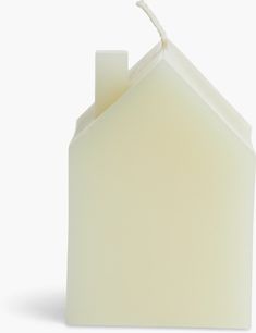 a house shaped candle holder with a white background