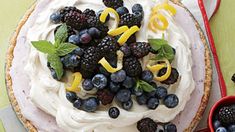 a pie topped with whipped cream and fresh berries