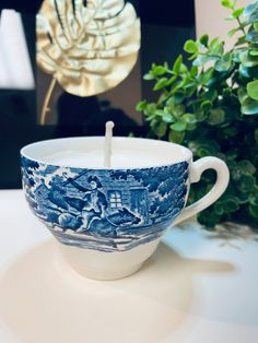 a blue and white cup sitting on top of a table