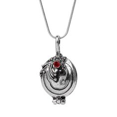 a silver necklace with a red stone in the center