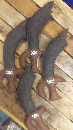 three pieces of leather sitting on top of a wooden table