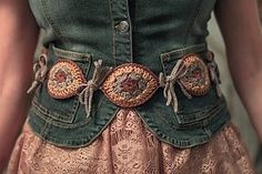 a close up of a person wearing a dress with buttons on the waist and belt