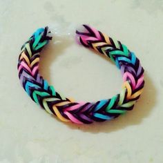 multicolored braid bracelet sitting on top of a table