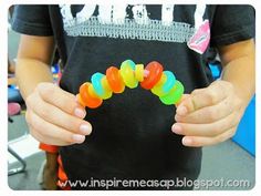 a young boy holding a bunch of gummy bears