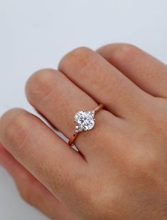 a woman's hand with a diamond ring on it