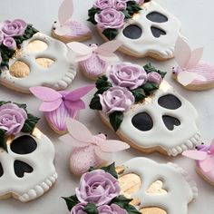 decorated sugar cookies in the shape of skulls and flowers