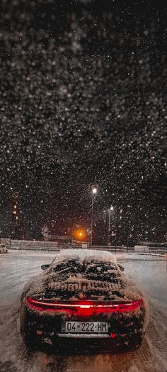 a car parked in the snow at night