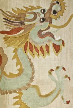 a close up of a dragon design on a white background with gold and red accents