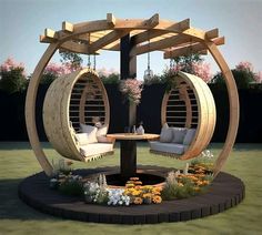 an outdoor seating area with two hanging chairs and a table in the middle, surrounded by flowers