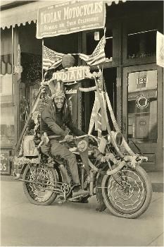 an old black and white photo of two people on a motorcycle