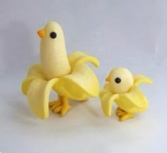 two small plastic yellow birds sitting next to each other