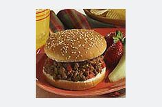 a hamburger with meat and vegetables on a plate