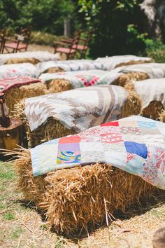 hay bales with colorful quilts and chairs in the background