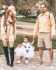 a man, woman and child dressed up in costumes