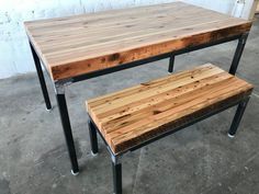 a table and bench made out of pallet wood with metal legs on concrete flooring