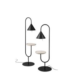 two black and white lamps sitting next to each other