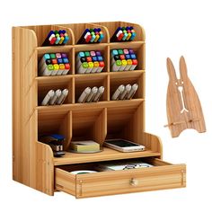 a wooden desk organizer with compartments for pens and pencils